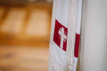 Valmiera, Letonia - 12 de mayo de 2024 - Detalle de una estola religiosa con emblema de cruz y abalorios.