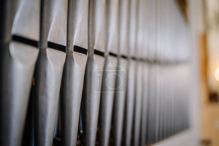 Valmiera, Latvia - May 12, 2024 - Close-up of metal organ pipes in soft focus, showing detailed craftsmanship.