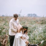 Riga, Latvia, - August 26, 2024 - a bride and groom are seen outdoors, enjoying a moment with their dog, symbolizing love and happiness.