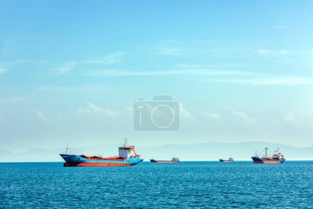 Photo for View of the cargo ship and transport for cargo (goods) with blue mediterranean sea and cloudy sky. - Royalty Free Image