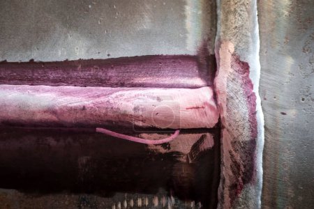 Photo for View of linear crack with dye liquid penetrant test. Dye penetrant inspection, also called liquid penetrate inspection or penetrant testing, is a widely applied and low-cost inspection method. - Royalty Free Image