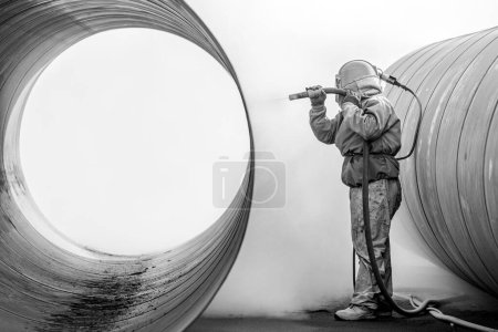 Photo for View of sandblasting before coating. Abrasive blasting, more commonly known as sandblasting, is the operation of forcibly propelling a stream of abrasive material against a surface. - Royalty Free Image