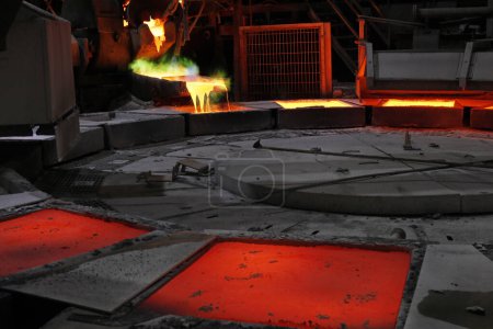 Photo for View of the copper casting to the molds in the smelting of the industrial plant. Smelting is a process of applying heat to ore in order to extract a base metal. - Royalty Free Image