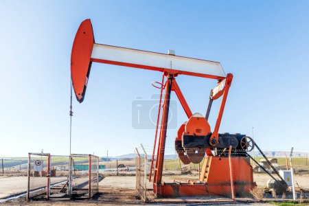 Photo for View of the pumpjack in the oil well. A pump jack is a device used in the petroleum industry to extract crude oil from an oilfield. - Royalty Free Image