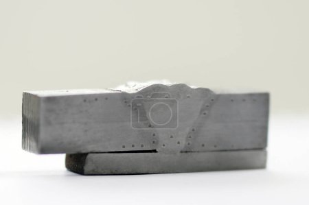 Photo for Macro and hardness test specimen of the groove or butt weld with electrode process for welding procedure qualification record. Macro examination is the procedure in which a specimen is etched. - Royalty Free Image