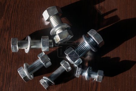 Photo for View of the bolts and nuts (fasteners). A bolt is a form of threaded fastener with an external male thread. Bolts are very closely related to screws. Bolts are often used to make a bolted joint. - Royalty Free Image