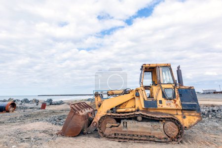 Téléchargez les photos : Vue de l'ancien bulldozer à chenilles sur le chantier. Pelle dans un chantier de construction. - en image libre de droit