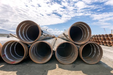 Photo for View of the steel pipe piles to build pier in the sea. Pipes on the construction site. - Royalty Free Image