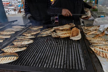 Photo for Fish and bread in the boat, Bosphorus, Eminonu, Istanbul, Turkey. Grilled fish in the market - Royalty Free Image
