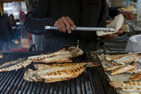 Photo for Fish and bread in the boat, Bosphorus, Eminonu, Istanbul, Turkey. Grilled fish in the market - Royalty Free Image