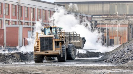 Photo for The big bulldozer and industrial pollution. Pollution is the introduction of contaminants into the natural environment that cause adverse change. Coal mining. - Royalty Free Image
