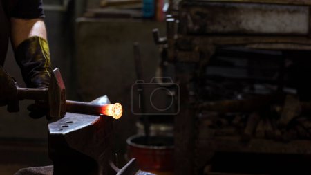 Photo for View of the blacksmith. A blacksmith is a metalsmith who creates objects from wrought iron or steel by forging the metal, using tools to hammer, bend, and cut. - Royalty Free Image