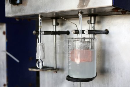Photo for Electrolysis of copper sulfate in lab. It takes place in an electrolytic cell where electrolysis which uses direct electric current to dissolve a copper rod and transport the copper ions to the item. - Royalty Free Image