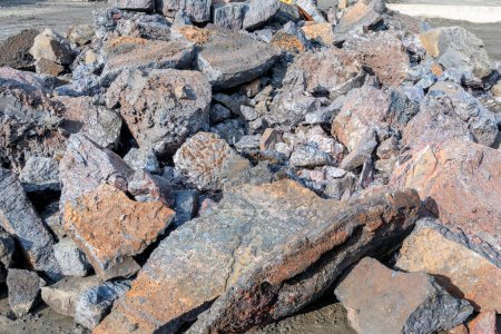Photo for View of the heap of the copper slag in the copper mine factory. Copper slag is a by-product of copper extraction by smelting. During smelting, impurities become slag which floats on the molten metal. - Royalty Free Image