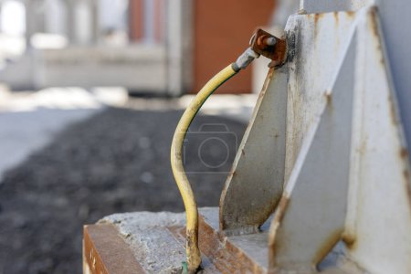 Photo for A typical earthing electrode (ground with electricity) to steel structure. Connection to ground also limits the build up of static electricity when handling flammable products. Construction of a earthing electrode on the background of cement - Royalty Free Image