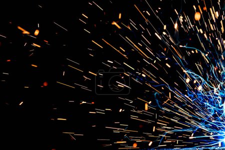 Photo for Close up view and background of the gas metal arc welding (GMAW) process with sparks, light, bokeh effect and smoke. Abstract background of sparks - Royalty Free Image