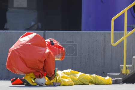 Photo for Worker lying on the ground due to gas leak. A gas leak refers to a leak of natural gas or another gaseous product from a pipeline or other containment into any area where the gas should not be present - Royalty Free Image