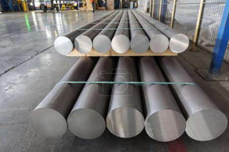 Aluminium (aluminum) production process and extrusion billets of aluminium in the factory. The conversion of alumina to aluminium metal is achieved by the Hall-Heroult process.