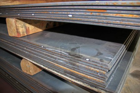 Photo for Carbon steel plates in manufacturing plant. carbon steel plate is used for products that require durability and strength but do not require the lower weight of a thinner metal sheet. - Royalty Free Image