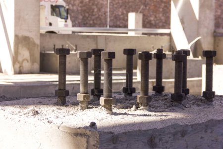 Photo for Close up view of the anchor bolts ( Foundation Bolts ) in the concrete. Anchor bolts are used to connect structural and non-structural elements to the concrete. The connection is made by an assembling of different components. - Royalty Free Image