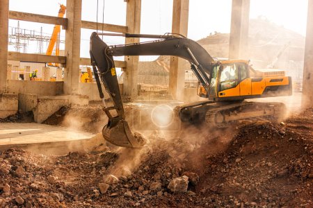 Photo for The excavator is digging in the building of the construction site. - Royalty Free Image