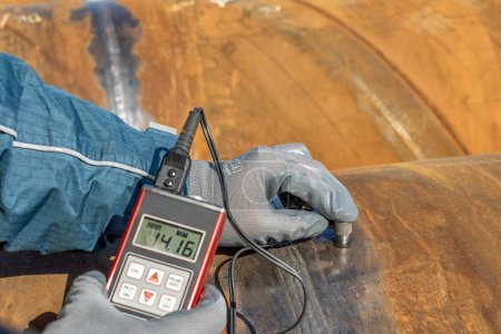 Photo for Technician is testing to pipe thickness with ultrasonic test method. Ultrasonic thickness measurement (UTM) is a method of performing non-destructive measurement (gauging) of the local thickness - Royalty Free Image