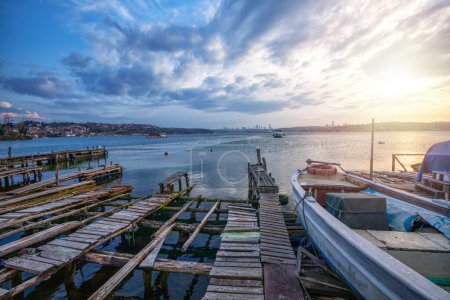 View of Beykoz coast and wooden piers. The Bosphorus coastal road runs up to Beykoz from Beylerbeyi (below the Bosphorus Bridge) and there are roads down to the coast from Fatih Sultan Mehmet Bridge. Boats in the sea. Beautiful sea view