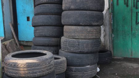 Photo for Pile of old tires and wheels for recycling rubber. tire patch on the side of the road. - Royalty Free Image