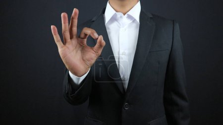 Business man hand with ok sign on white background