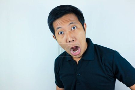 funny expression of shocked and surprised Asian man isolated on white background