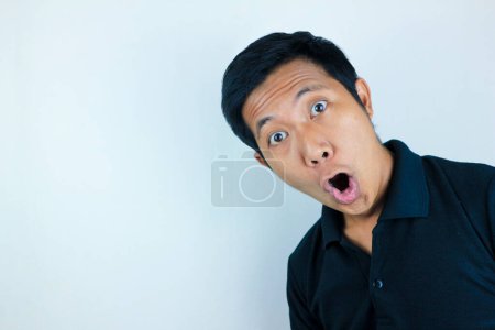 funny expression of shocked and surprised Asian man isolated on white background