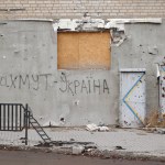 Bakhmut, UKRAINE JAN 19 2023 The writing 'Bakhmut is Ukraine' on the wall of damaged by russian shelling building at Bakhmut during russian invasion to Ukraine