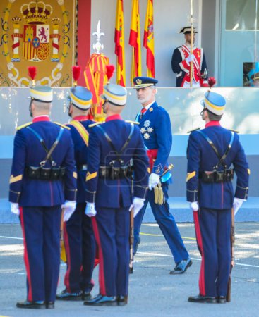 Photo for Felipe VI approaching the guard of honour . Some 4,100 military personnel participated during the National Day military parade including King Felipe VI, Queen Letizia, and Princess Leonor, in Madrid Spain. - Royalty Free Image