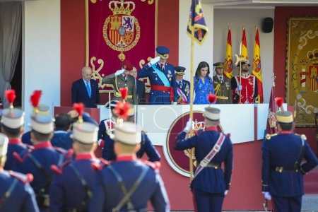 Photo for Felipe VI and Princess Leonor saluting . Some 4,100 military personnel participated during the National Day military parade including King Felipe VI, Queen Letizia, and Princess Leonor, in Madrid Spain. - Royalty Free Image