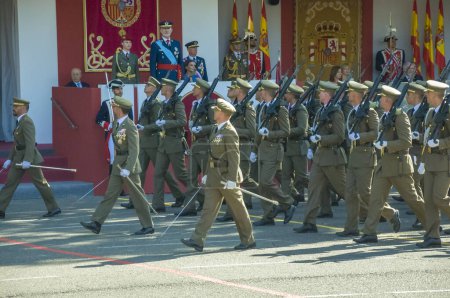 Photo for Marching soldiers in green uniform, some 4,100 military personnel participated during the National Day military parade including King Felipe VI, Queen Letizia, and Princess Leonor, in Madrid Spain.i - Royalty Free Image