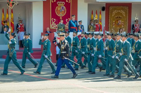 Photo for Marching  Guardia Civil including a French police officer, some 4,100 military personnel participated during the National Day military parade including King Felipe VI, Queen Letizia, and Princess Leonor, in Madrid Spain.i - Royalty Free Image