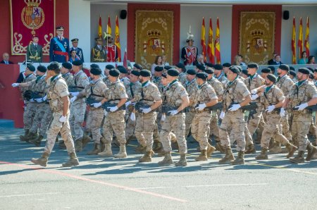 Photo for Marching soldiers in camouflage uniform, some 4,100 military personnel participated during the National Day military parade including King Felipe VI, Queen Letizia, and Princess Leonor, in Madrid Spain.i - Royalty Free Image
