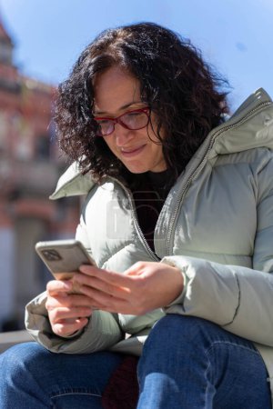 Téléchargez les photos : Femme bavarder avec son smartphone - en image libre de droit