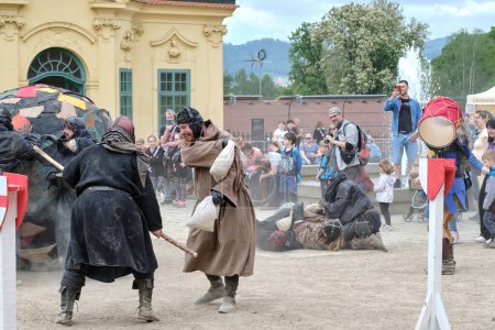 Photo for Decin (Tetschen-Bodenbach), Czech Republic - May 14 2023: Town festivities on the Decin castle, one of the Czech oldest and largest heritage sites, funny show "Monks play football" with people in medieval costumes sack fighting for a huge ball. - Royalty Free Image