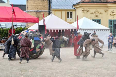 Photo for Decin (Tetschen-Bodenbach), Czech Republic - May 14 2023: Town festivities on the Decin castle, one of the Czech oldest and largest heritage sites, funny show "Monks play football" with people in medieval costumes sack fighting for a huge ball. - Royalty Free Image