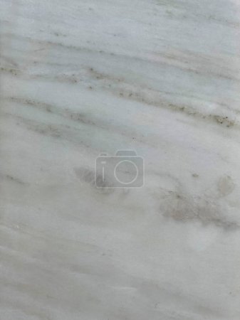Photo for Marble Tile texture closeup as an abstract background. Natural Honed stone slab. Details of matte ceramic wall or floor. Gray surface with satin finish and a pattern of random irregular white spots. - Royalty Free Image