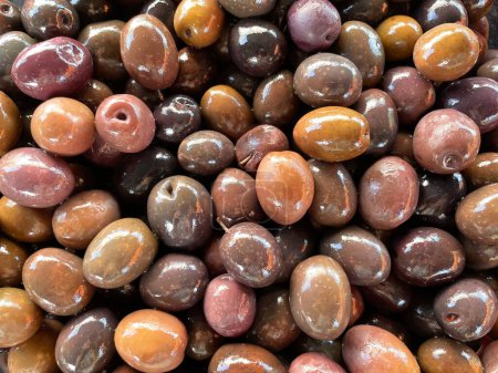 Photo for Many Whole Kalamata olives come from the famous Kalamata region of Greece. Lots of olives as a background. Top view. Organic and fresh ready for sale and eating. Mediterranean snacks - Royalty Free Image