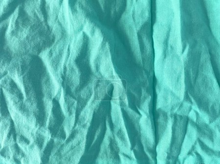 Texture of seamless fabric in turquoise color. Close-up of natural linen fabric background texture. Fashionable texture. Vintage pattern. Turquoise print.