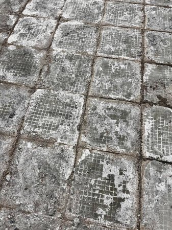 gray paving tiles with cracks on gray sidewalk