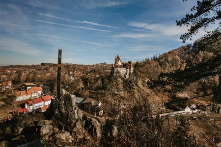 Photo for Bran castle or Count Dracula Castle view from viewpoint on hill with cross. Medieval fortress in Romania, popular travel destination and touristic landmark. Gothic vampire castle in haunted forest. - Royalty Free Image