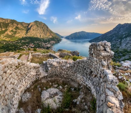 Photo for Tiny woman in massive landscape with ruins of ancient Illyrian fort Rizon. Historical site, remains of the oldest settlement in Boka Kotorska above the town of Risan. Travel Montenegro concept. - Royalty Free Image