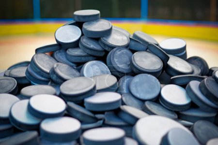 Photo for Huge pile of real Hockey Pucks. blurred playground background. selective focus image - Royalty Free Image
