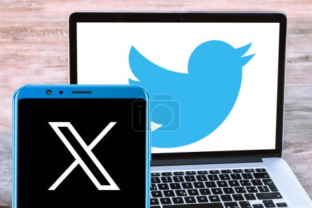 Foto de CHENNAI, INDIA, 24 DE JULIO DE 2023: logotipo de Twitter X en la pantalla móvil y logotipo de Twitter en el fondo de la pantalla del portátil - Imagen libre de derechos