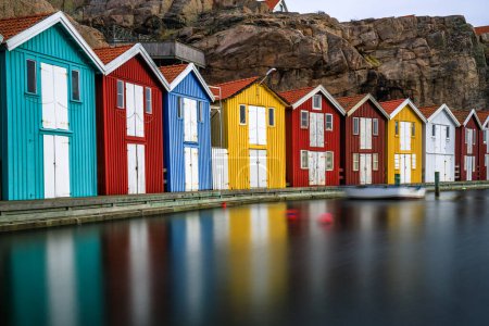 Photo for Sweden houses, small colorful fishermen's houses in Sweden smog. A great city right by the sea with a rock in the background - Royalty Free Image