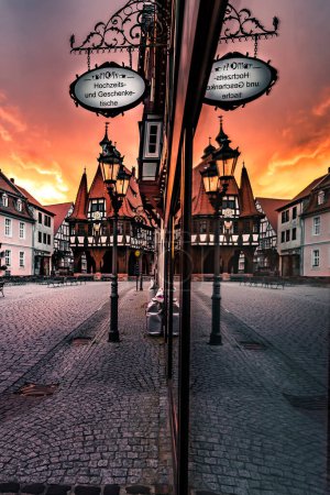 Photo for The beautiful historic village in Hessen Germany is called Michelstadt. Here you can see part of the old town with its Gothic half-timbered houses, the wheel house in the sunrise in the morning - Royalty Free Image